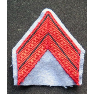 Galon de caporal rouge sur tissu bleu clair avec crochets