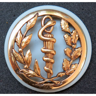 Insigne de béret du service de santé Coinderoux sur son support plastique gris perle