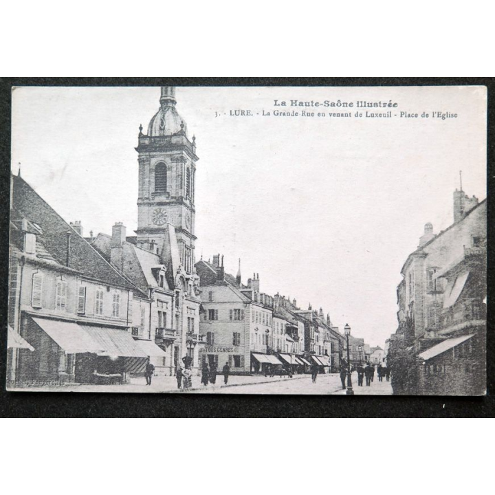 Carte postale Lure (Haute Saône) n° 1 La Grande Rue en venant de Luxeuil Place de l'Eglise